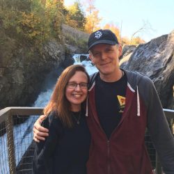 husband and wife at waterfall