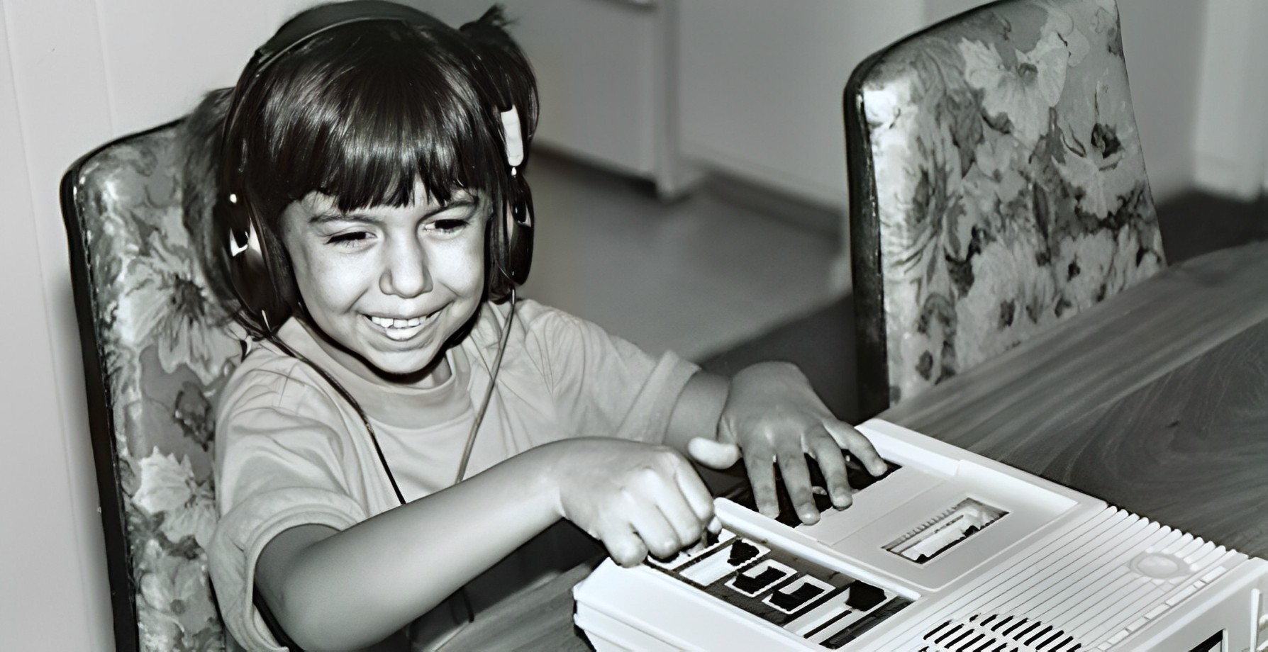 a young blind girl listens to an audio book on cassette 