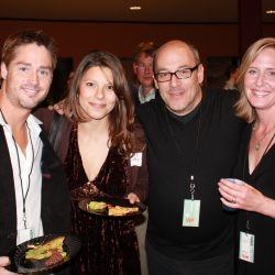 4 people taking a group photo at a business event