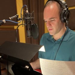 Man in ISO Booth reading a script