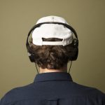 rear view of man listening to music on headphones